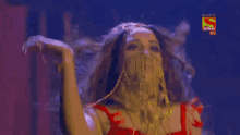 a woman is dancing in front of a screen that says sony sab h2