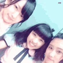 three young women are posing for a picture together and smiling .