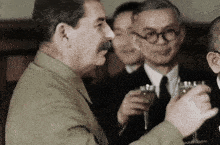 a man with a mustache is holding a glass of champagne