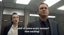 a man in a suit and tie stands next to a woman who says " a whiff of homo-erotic tension? how exciting "