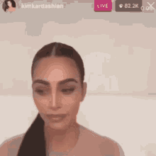 a close up of a woman 's face with a live button in the upper right corner