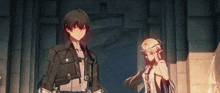 a boy and a girl are standing next to each other in a dark room