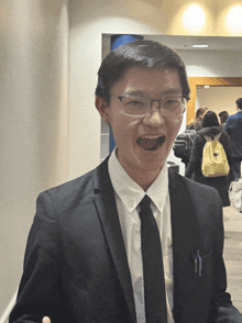 a man wearing a suit and tie with a pen in his pocket that says ' columbia ' on it