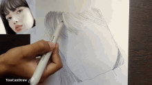 a person is drawing a picture of a woman 's face with a pen that says youcandraw