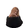 a woman in a black sweater is making a heart with her hands .