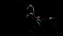a man singing into a microphone with his hands outstretched