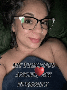 a woman wearing glasses is laying under a blanket with the words " my precious angel my eternity " on it