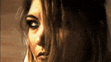 a close up of a woman 's face with her hair covering her eyes
