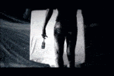 a black and white image of a person holding a brush