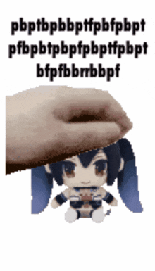 a hand is putting a stuffed doll on top of a white background
