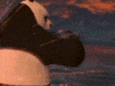 a panda bear is standing in front of a painting and looking at something .
