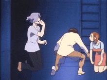 a man and two women are standing next to each other in a room .