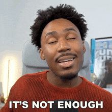 a man says it 's not enough in a red sweater