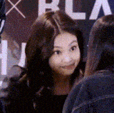 a woman is making a funny face while talking to another woman .