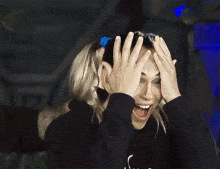 a woman with a blue headband on her head is smiling