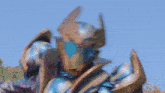 a blurred image of a superhero with a blue sky in the background