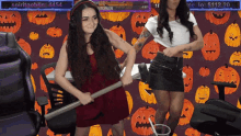 two women are dancing in front of a pumpkins background with the name spiritgoblin on the bottom