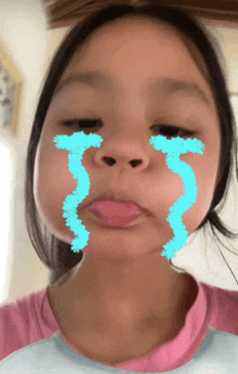 a young girl with blue tears on her face