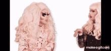 two drag queens standing next to each other on a white background