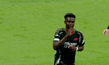 a soccer player wearing a emirates fly better jersey