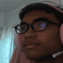 a man wearing glasses and headphones with a microphone