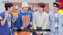 a group of young men are standing next to each other with one wearing a duf sweatshirt