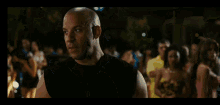 a man in a yellow shirt is pointing at another man in front of a car