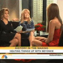 a woman in a red dress is being interviewed on a television show