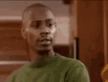 a man in a green shirt is talking and says `` i 'm busy '' .