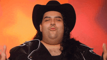 a man with long hair is wearing a cowboy hat and a leather jacket