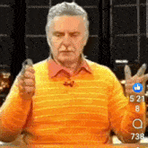 a man in an orange sweater is giving a peace sign in front of a thumbs up button