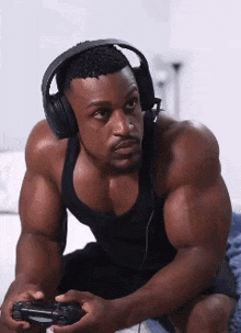 a muscular man wearing headphones and holding a game controller