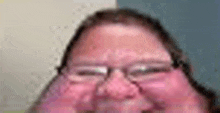 a close up of a man 's face with glasses and a red face .