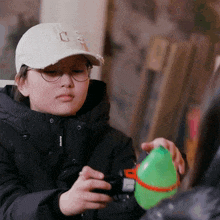 a boy wearing glasses and a hat with the letter c on it
