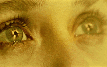 a close up of a person 's eyes with a hole in the middle