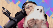 a woman wearing headphones is holding a small white dog
