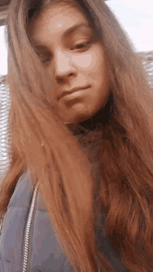 a woman with long hair is wearing a purple jacket