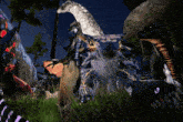 a group of dinosaurs are gathered together in the grass