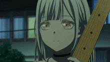 a girl with blonde hair is holding a guitar in her hand