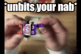 a person is holding a toy with the words " unbits your nab " written above it