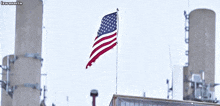 an american flag is flying in the wind in front of a building with a caption that says lewanartn