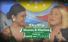 two women are standing next to each other with a sign that says shukla
