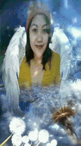 a woman in a yellow shirt with white wings is in the water