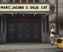 a sign for marc jacobs x doja cat hangs above the entrance