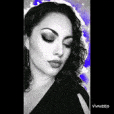 a black and white photo of a woman 's face with a blue background