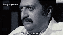 a black and white photo of a man with a mustache saying `` his word is rule '' .