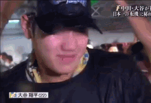 a close up of a man wearing a hat with chinese writing on it