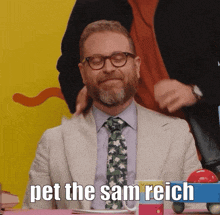 a man in a suit and tie with the words pet the sam reich written below him