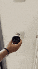 a person is holding a device with the number 229 on the screen