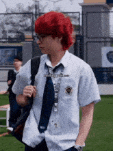 a man with red hair and glasses is wearing a white shirt and tie